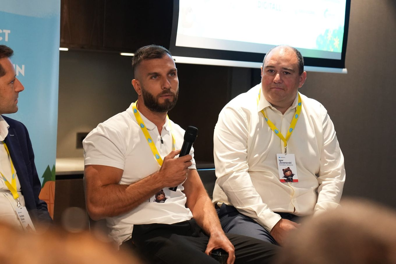 Dimitar Bonev speaking into a microphone while another panelist listens.